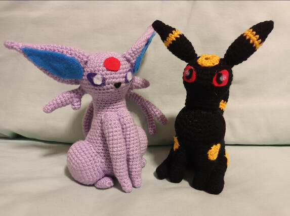 2 crochet pokemon plushies. One of the pokemon Espeon and one of the pokemon Umbreon.