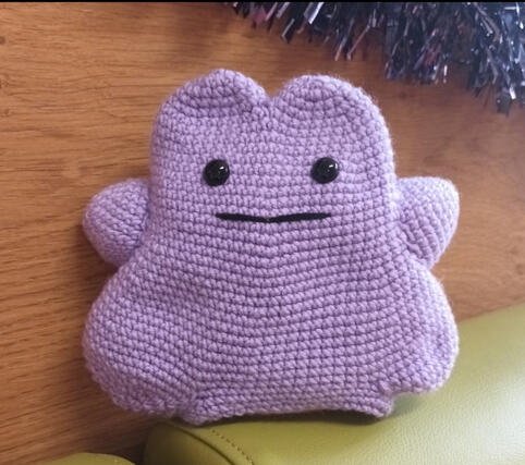 A crocheted plush of the pokemon Ditto.
