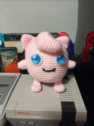 A crocheted plushie of the pokemon Jigglypuff.